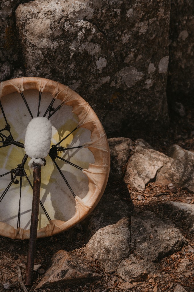 Shamanic drum resting by natural rocks